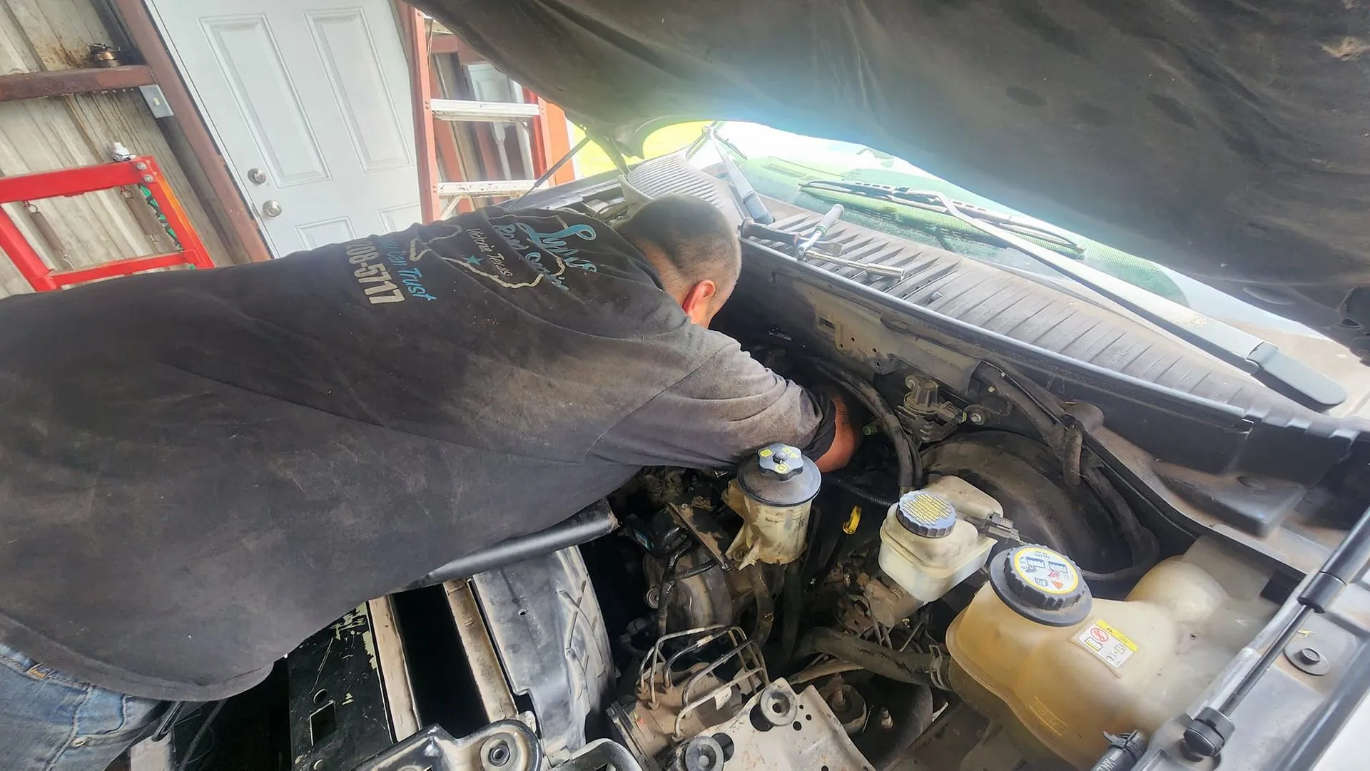 Mechanic working on a car engine